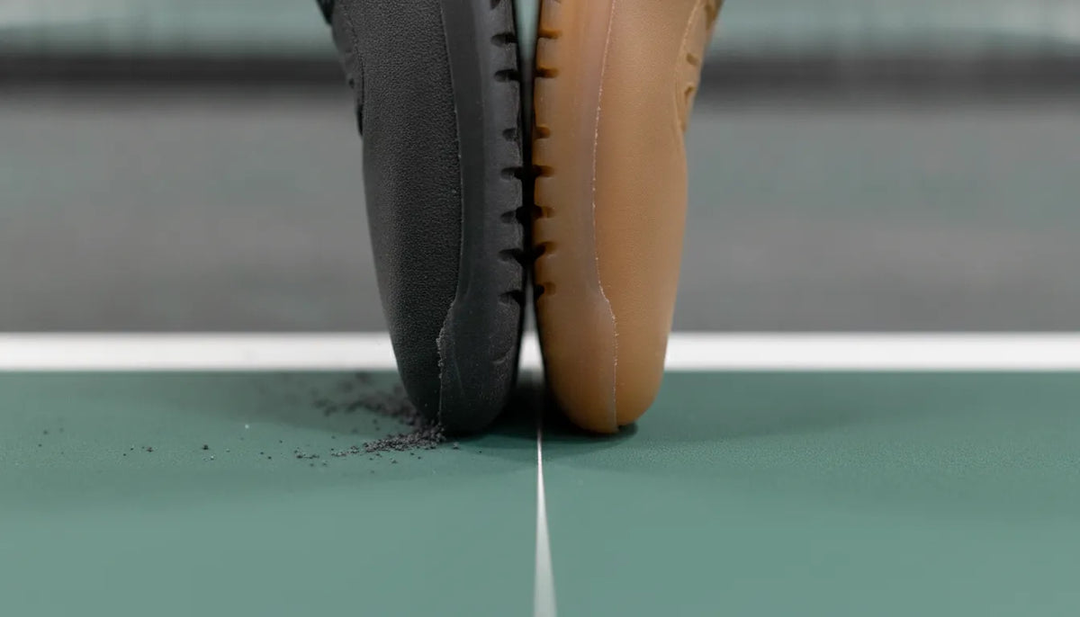 Two outsole rubber compounds meeting a pickleball court surface