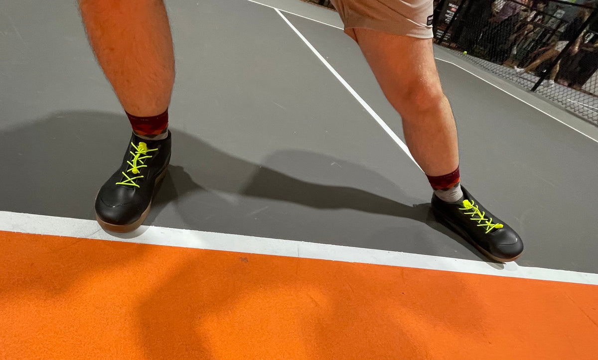 Lateral Control Pro pickleball shoe on an outdoor court, illustrating lightweight mid-cut court shoes for lateral stability.