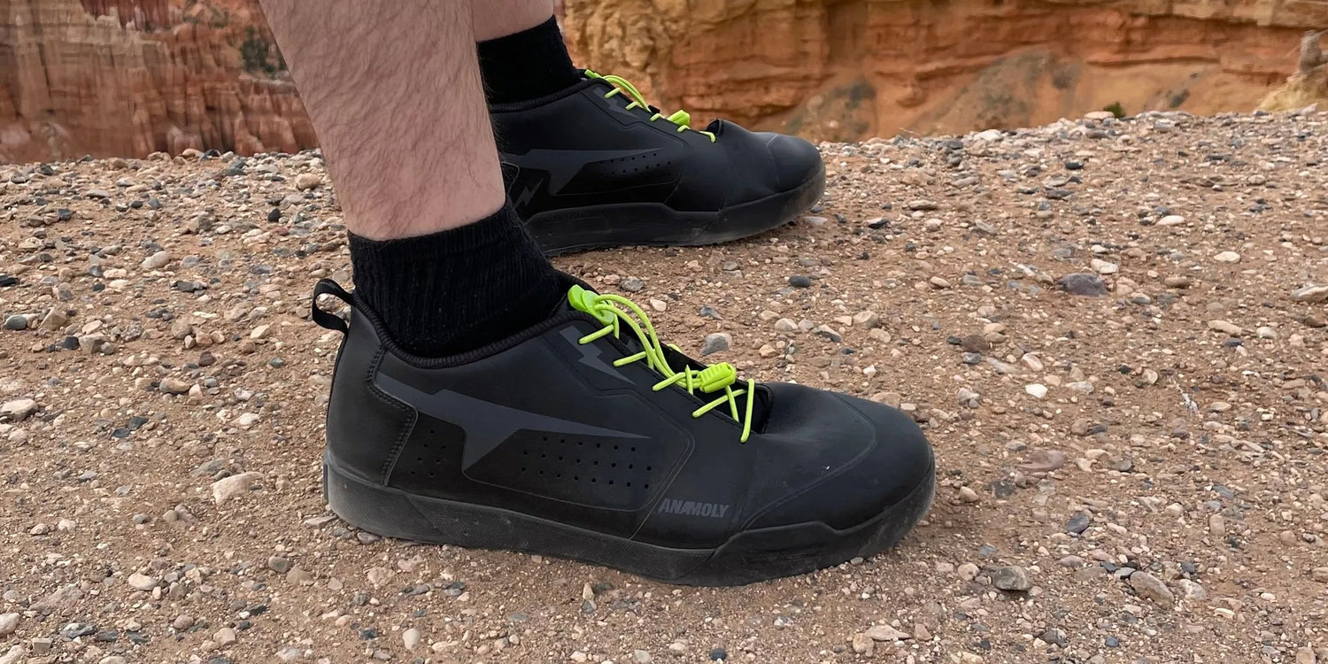 Mountain bike shoe on rocky trail terrain showing outsole tread pattern